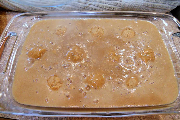 A glass baking dish with chomeur dough and maple cream before baking.