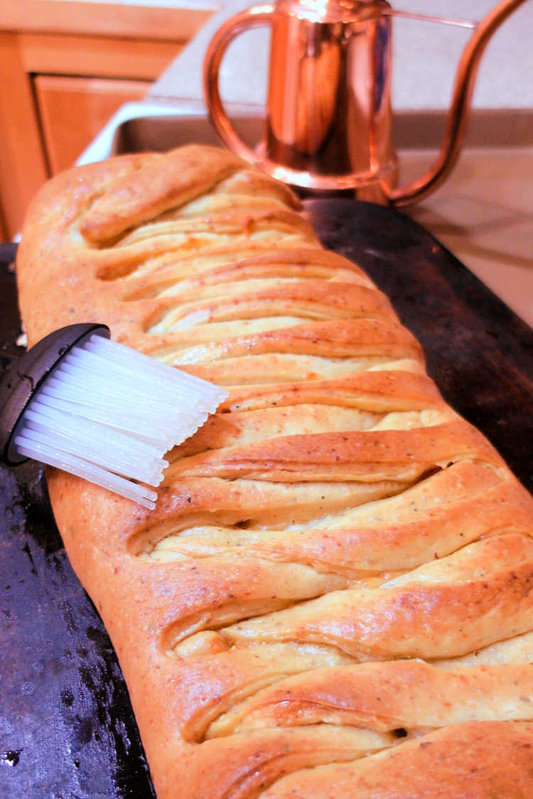 A whole baked braided pepperoni bread loaf.