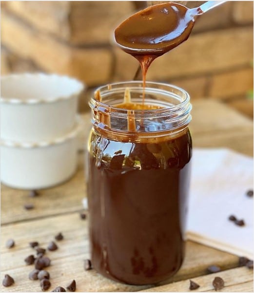 A jar of hot fudge sauce.