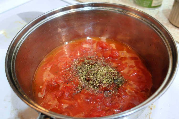 A sauce pan of tomato sauce for pepperoni cheese bread.