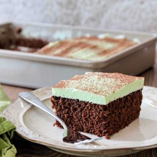 a piece of chocolate sheetcake with mint buttercream on a plate