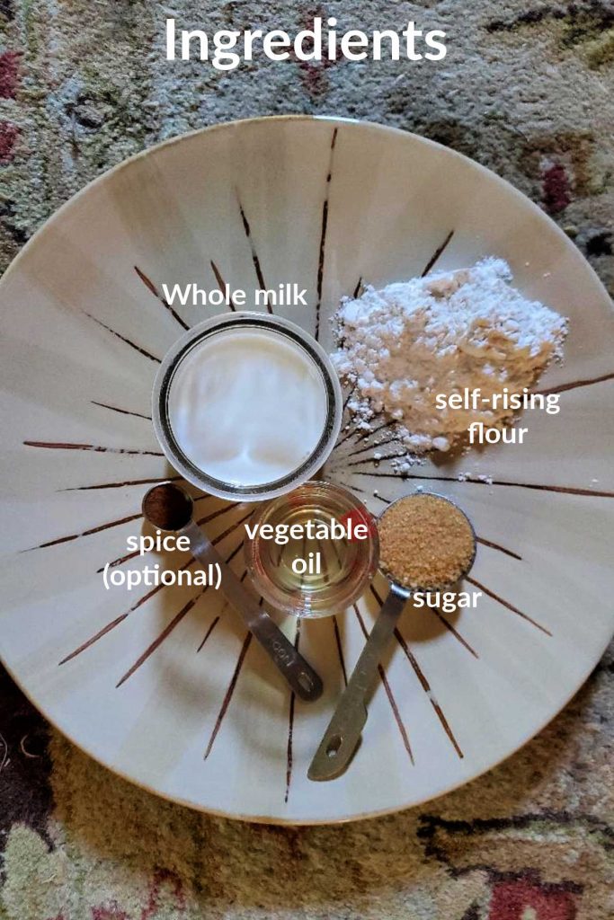 overhead shot of ingredients for pancakes for one. text reads "ingredients whole milk, self-rising flour, sugar, vegetable oil, spice (optional)"