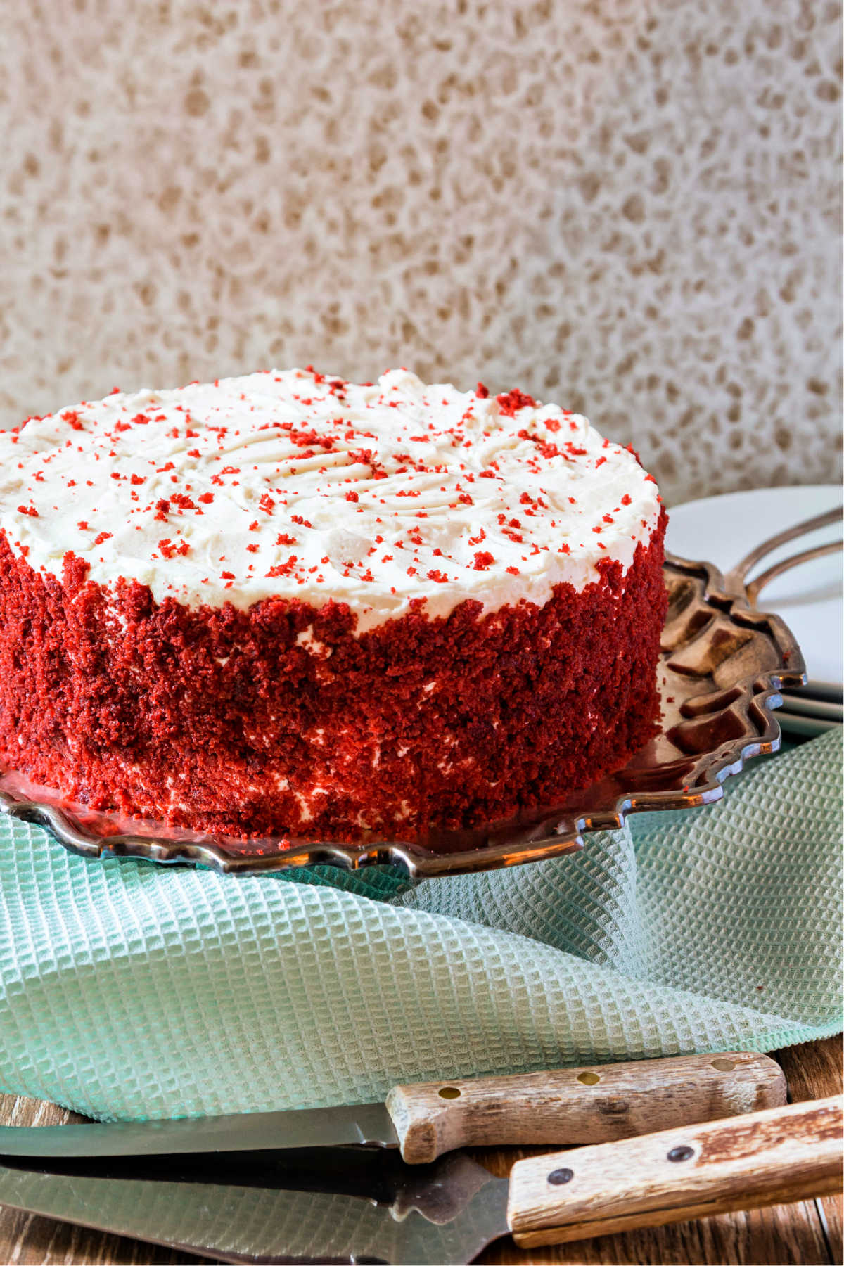 A cake frosted with ermine buttercream frosting on a cake plate.