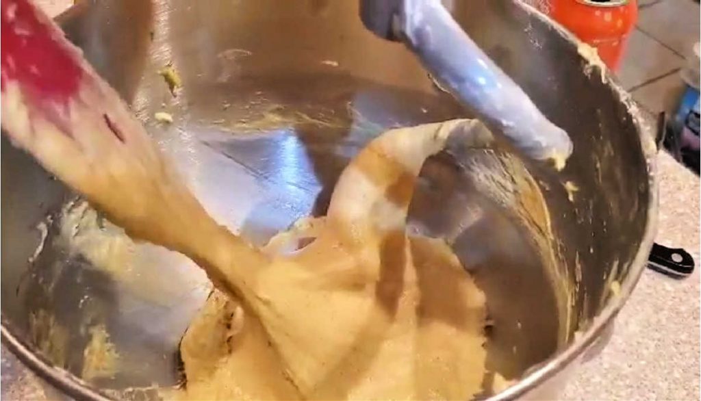 A very wet dough in a mixer bowl.