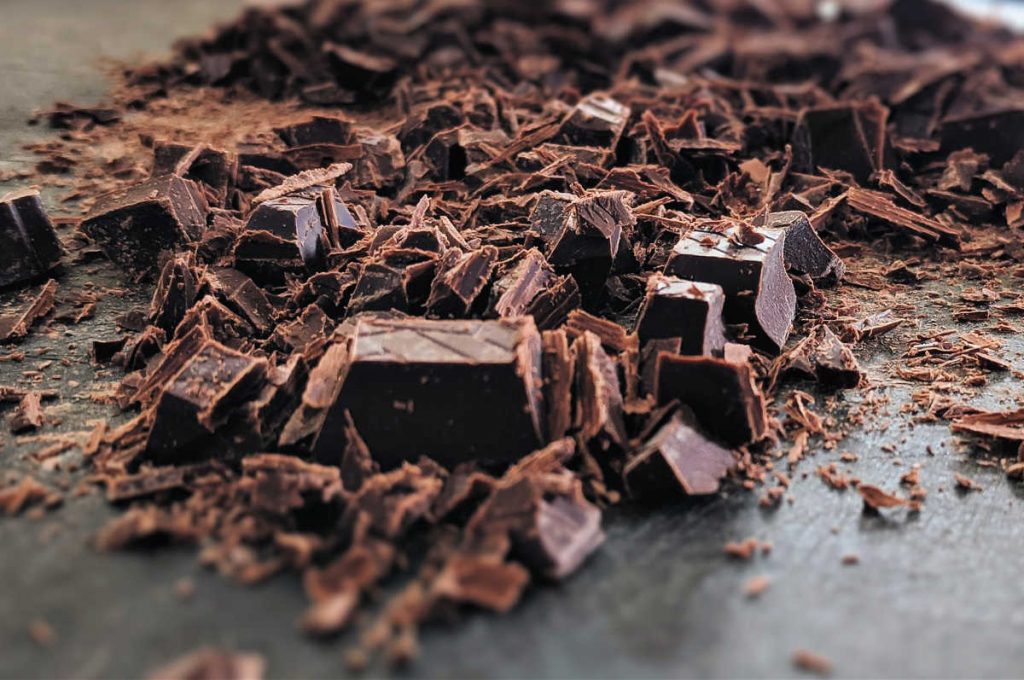 Lots of irregularly chopped dark chocolate, some in large pieces and some in very small pieces.