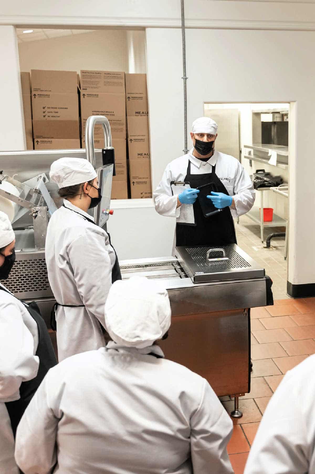 A culinary instructor teaching students at a culinary school.