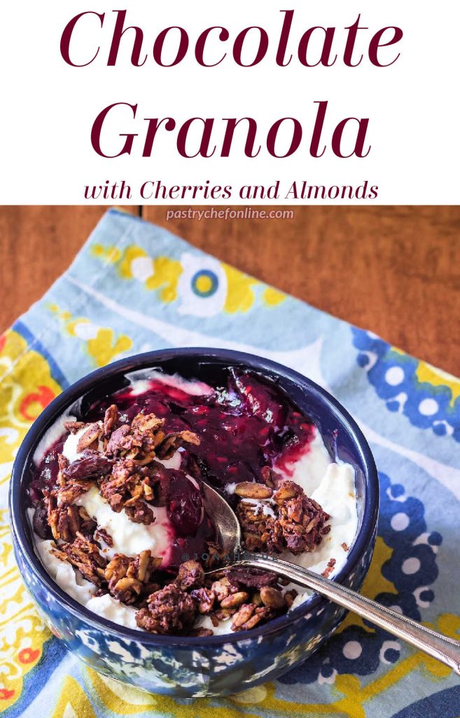 Bowl of yogurt and granola. Text reads "Chcolate Granola with cherries and almonds."