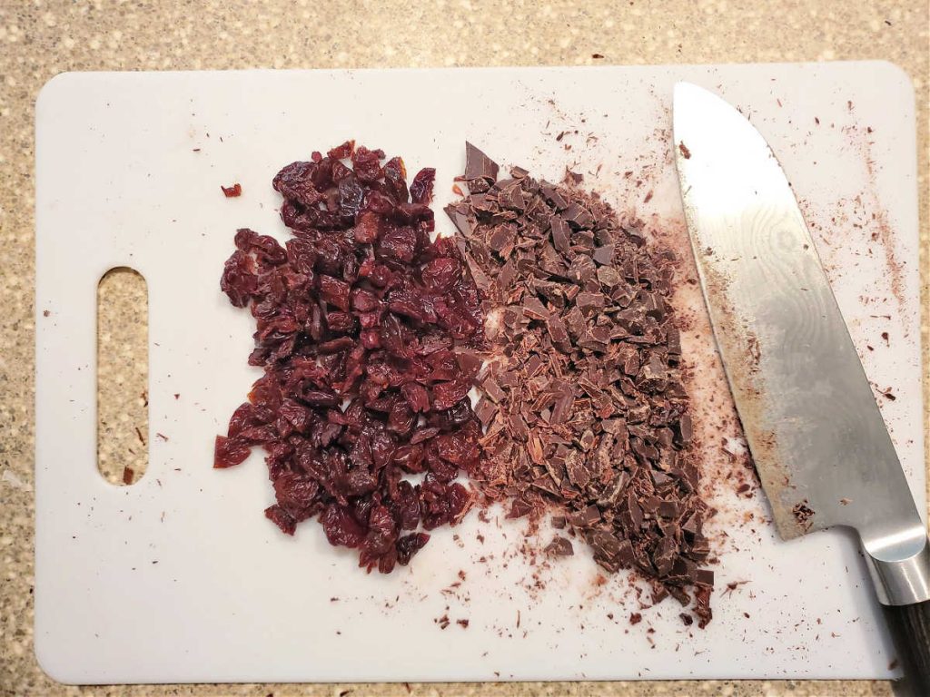 Overhead shot of chopped dried cherries and finely chopped dark chocolate.
