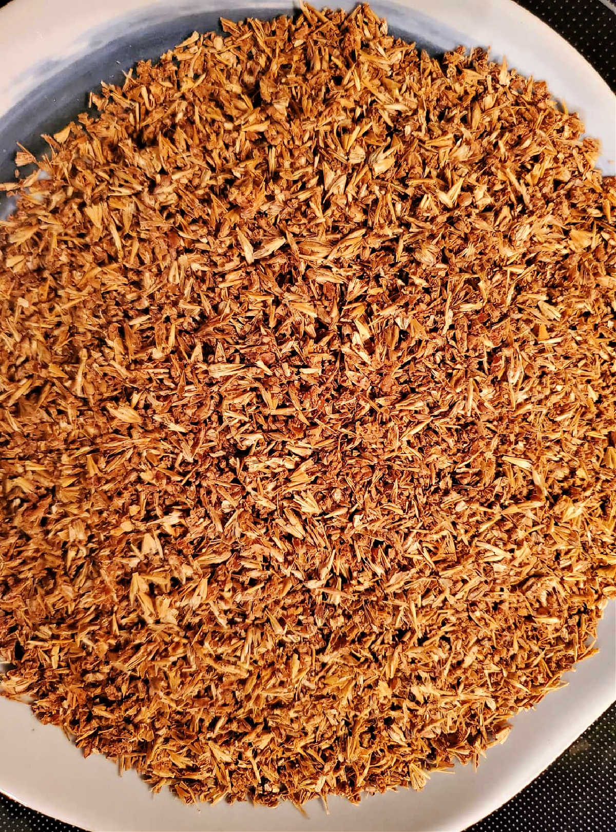 An overhead shot of cracked and dried spent grains from brewing beer.