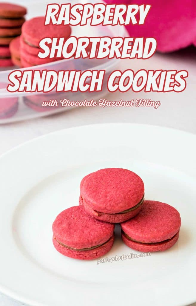Bright pink raspberry shortbread cookies on a white plate. Text overlay reads, "raspberry shortbread sandwih cookies with chocolate hazelnut filling."