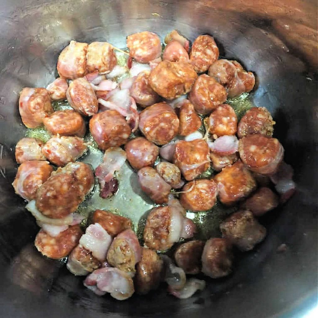 Chopped bacon and sausage cookin in the Instant Pot.