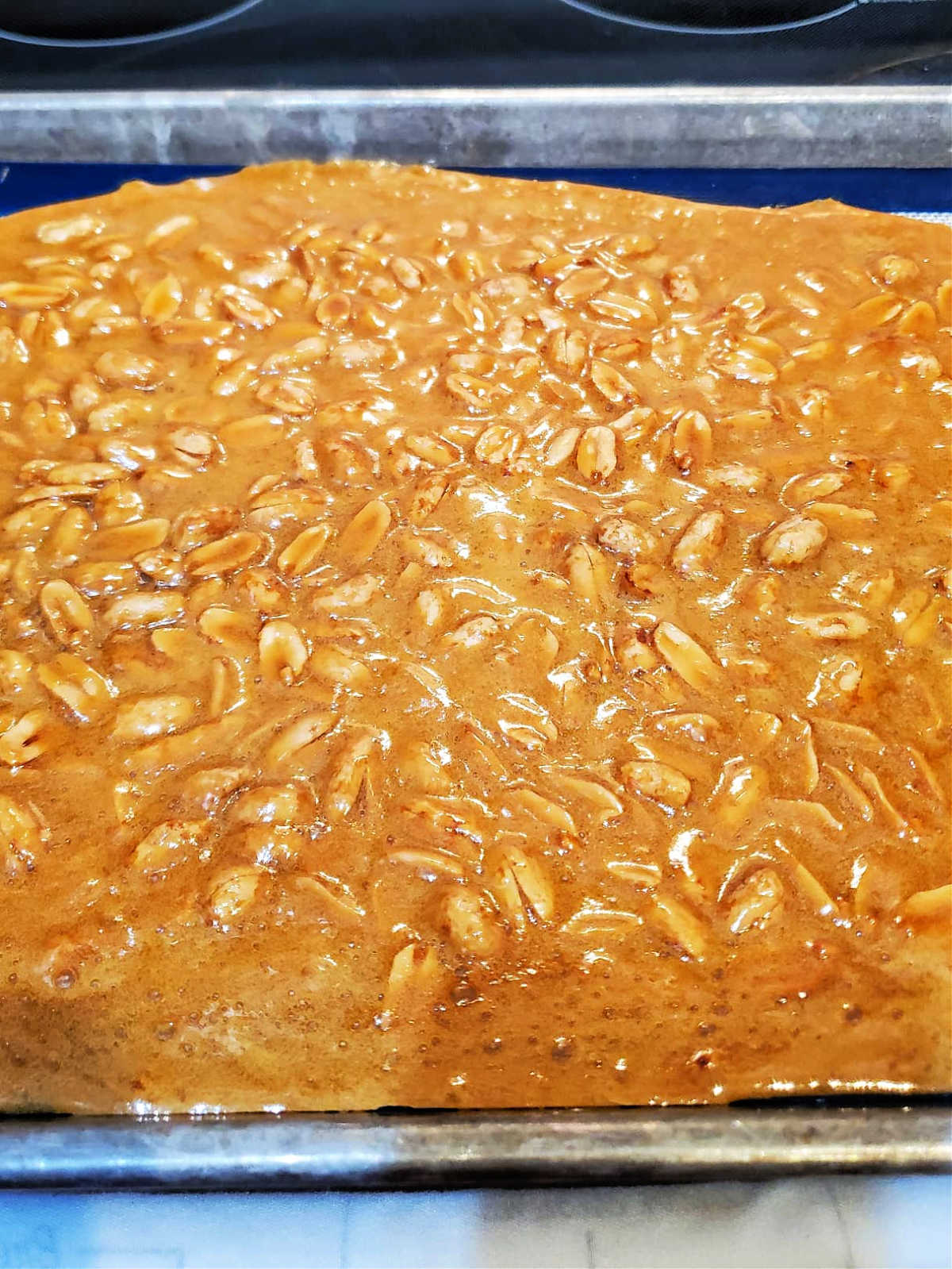 Peanut brittle cooling in a pan.