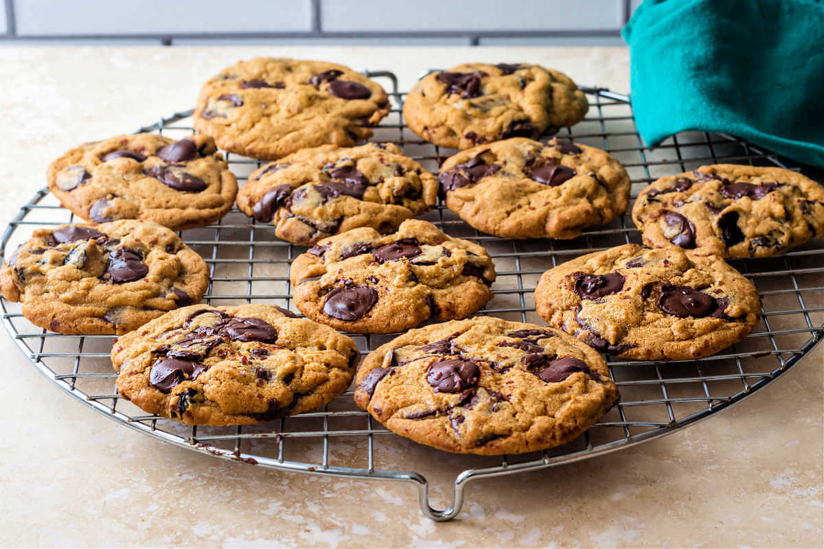 Chocolate chip cookies on a cooling rack.