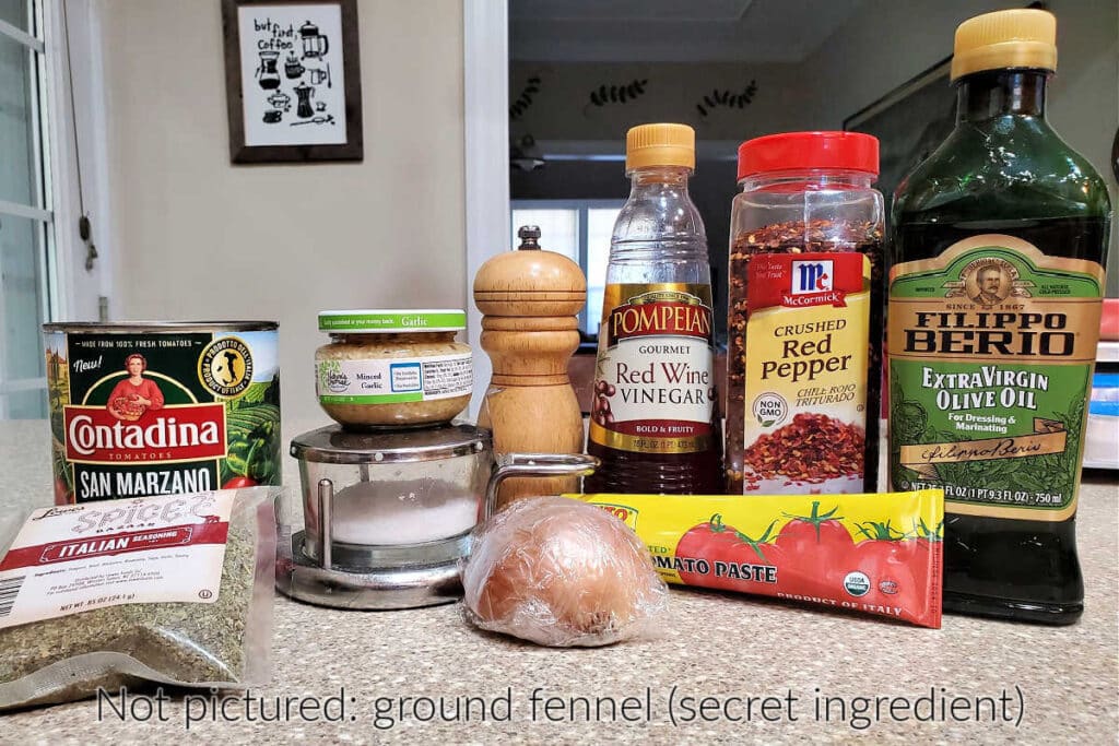 All the ingredients needed to make this cooked pizza sauce. Text overlay reads "Not pictured: ground fennel (secret ingredient)."