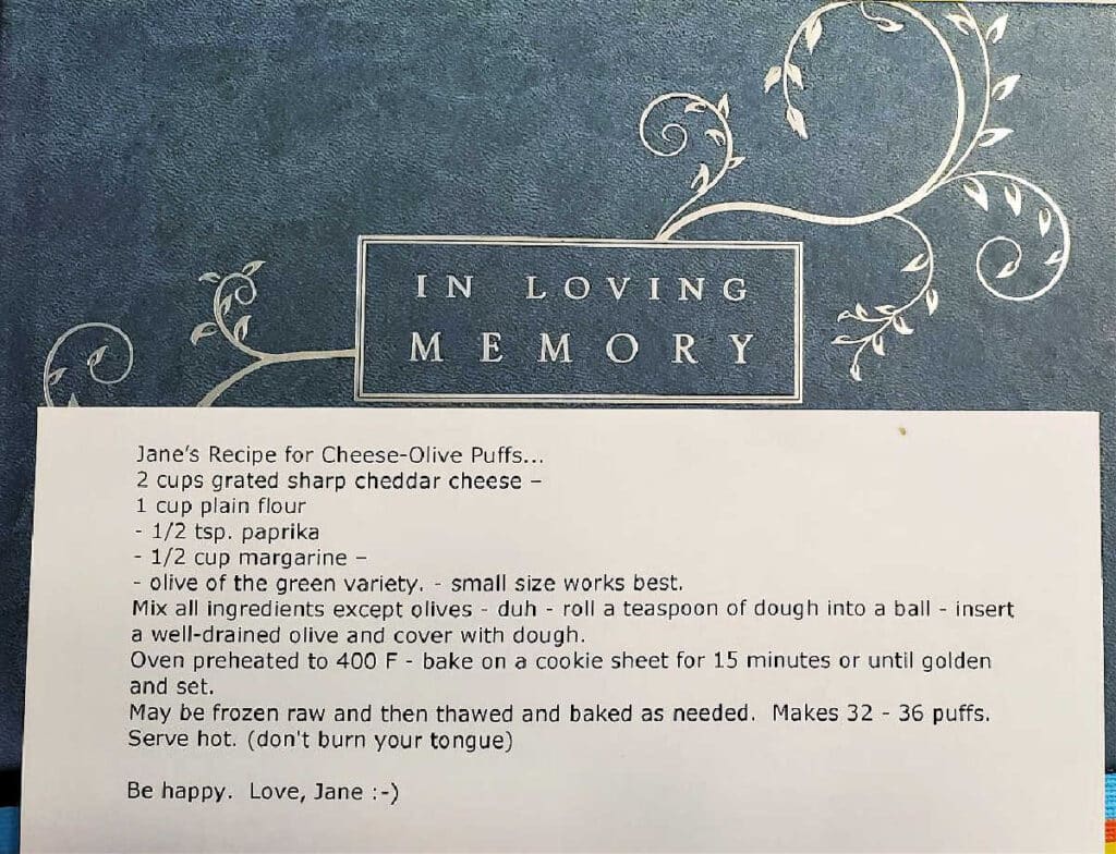 A typed recipe for "Janie's Cheese Olive Puffs" typed up on white copy paper.