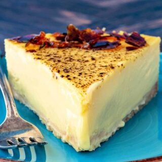 A slice of creme brulee cheesecake on a blue plate.
