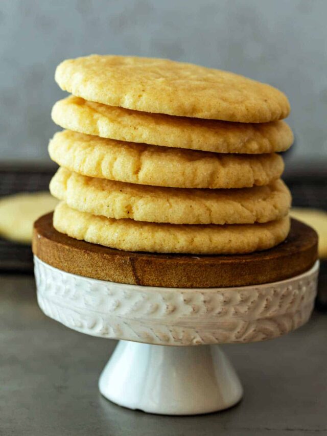 A stack of sugar cookies on a small pedestal.