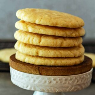 A stack of sugar cookies on a small pedestal.