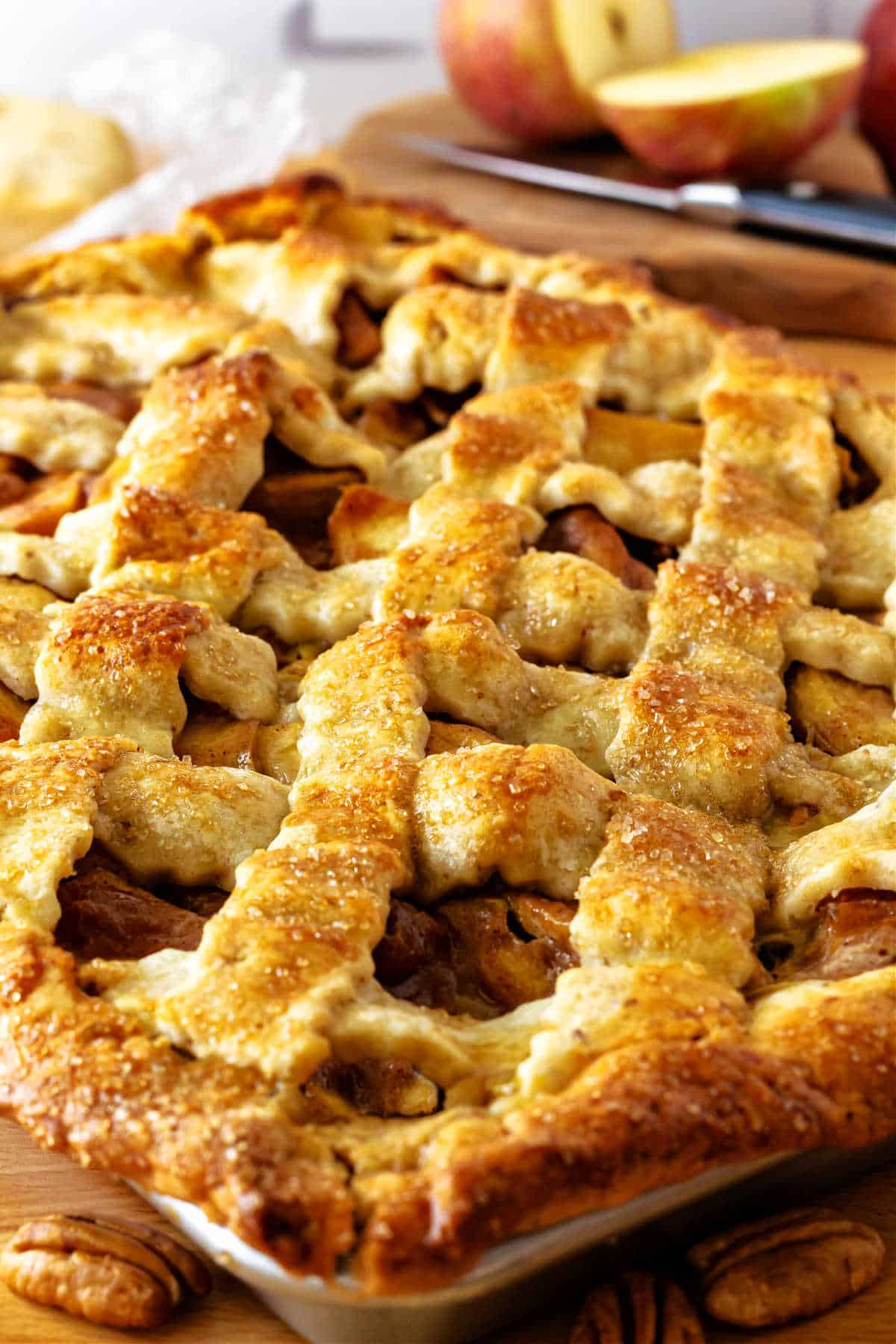 A closeup of an apple custard slab pie with lattice top.