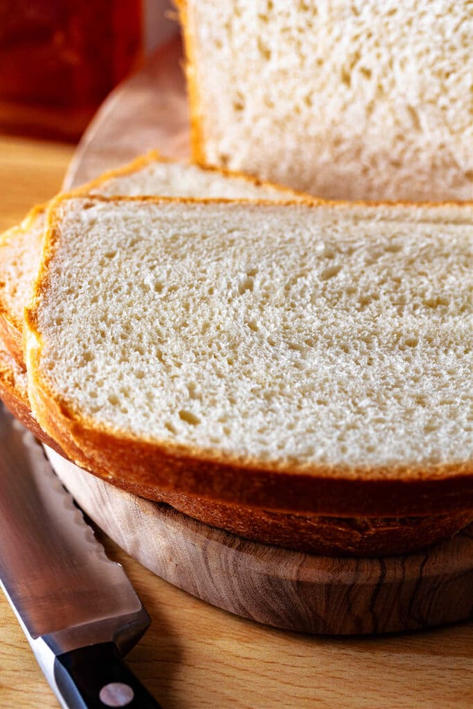 A close-up of freshly cut milk and honey bread.