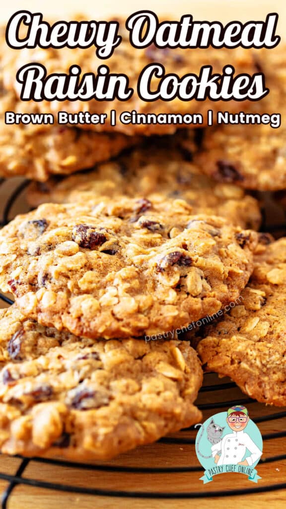 A close-up of large, thick and chewy oatmeal raisin cookies on a circular rack. This is a pin image, and the text reads: "Chewy Oatmeal Raisin Cookies: Brown butter, cinnamon, nutmeg."