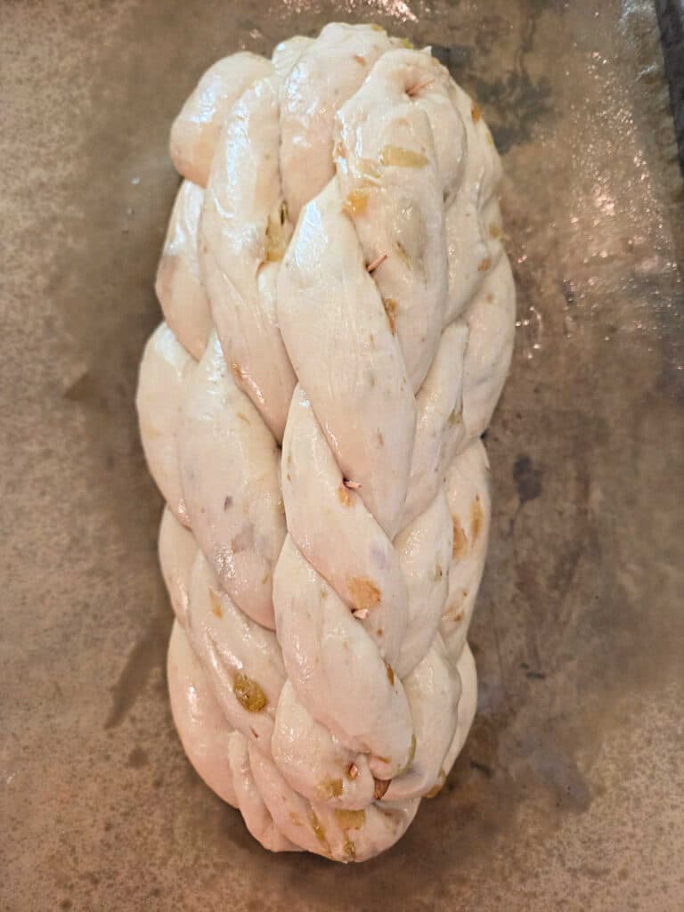 An overhead shot of a beautifully braided, unbaked houska ready for the oven.