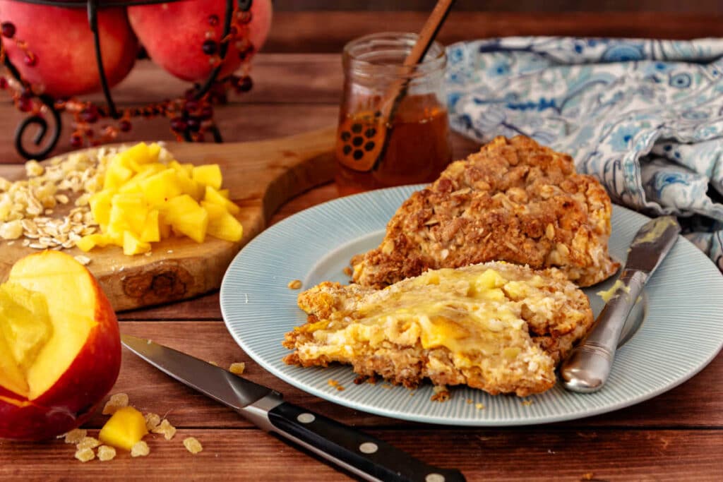 A peach and cream ginger scone split open and slathered with melted butter and honey.