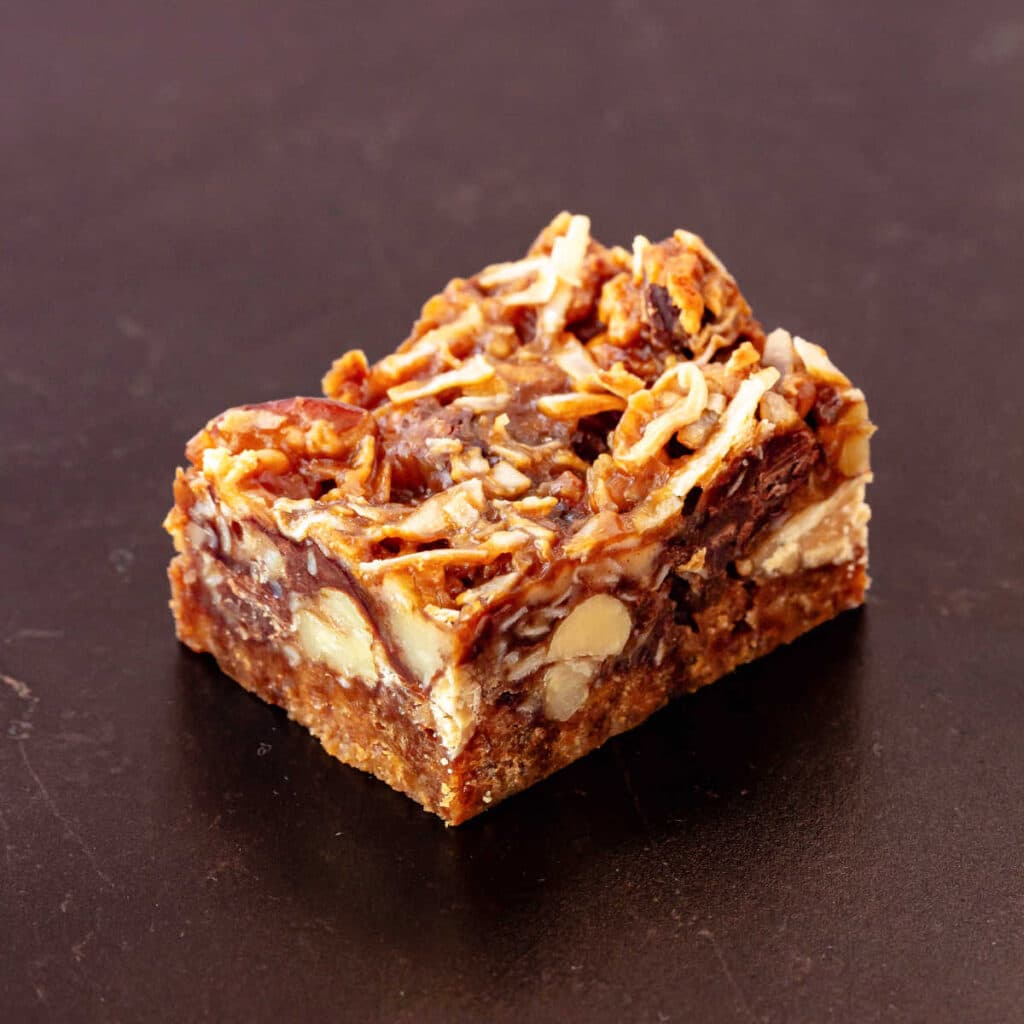One magic bar featuring peanuts, pecans, butterscotch sauce, and peanut butter.