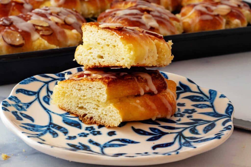 A bear claw sliced in half showing a cross section of the almond-filled pastry.